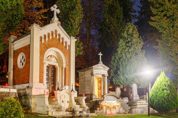 LVIV, UKRAINE - November 01, 2020: Lychakiv cemetery is a grave at night on All Saints' Day