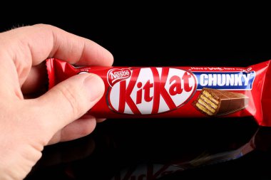 LVIV, UKRAINE - 27 Nisan 2020: Kit Kat in hands black background