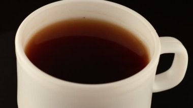 Siyah arka planda bir fincan kahve.