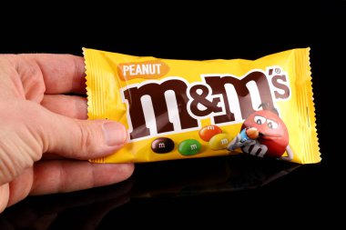 LVIV, UKRAINE - Nisan 06, 2020: M & Ms in hand black background