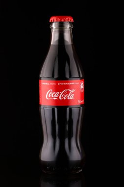 LVIV, UKRAINE - Nisan 06, 2020: Coca Cola cam şişe koyu arkaplan