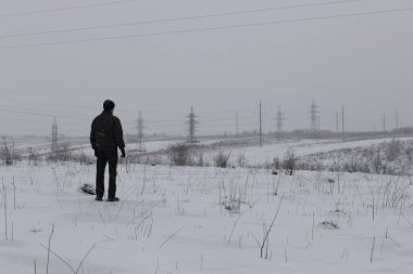 Lonely man standing in the snow