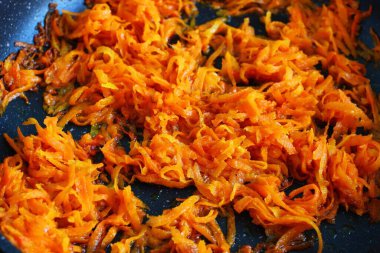 Braising carrots in the kitchen close-up