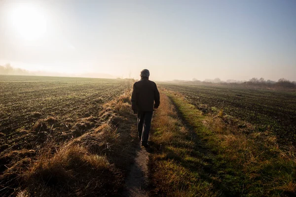 A man is walking on a country road