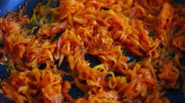 Braising carrots in the kitchen close-up