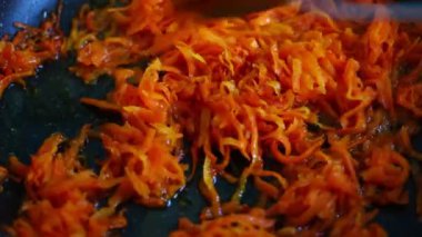 Braising carrots in the kitchen close-up