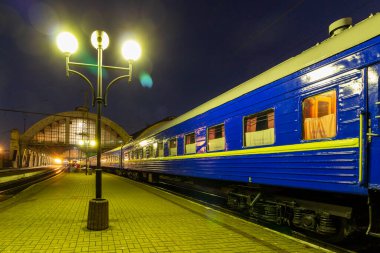 LVIV, UKRAINE - October 13, 2019: Passenger train at the train station at night