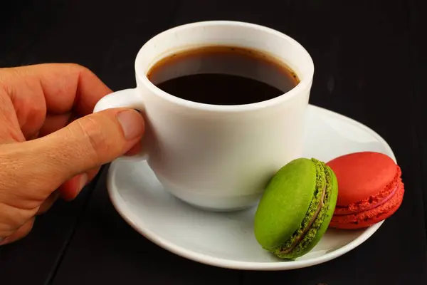 Hand Takes Macaron Coffee Cookies Black Background — Stock Photo, Image