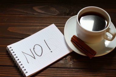 Bir fincan kahvenin yanındaki defterde yazmıyor ve yazmıyor.