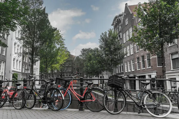 Amsterdam 'ın eski bir bölgesindeki bir kanalı geçen köprüde bisikletler
