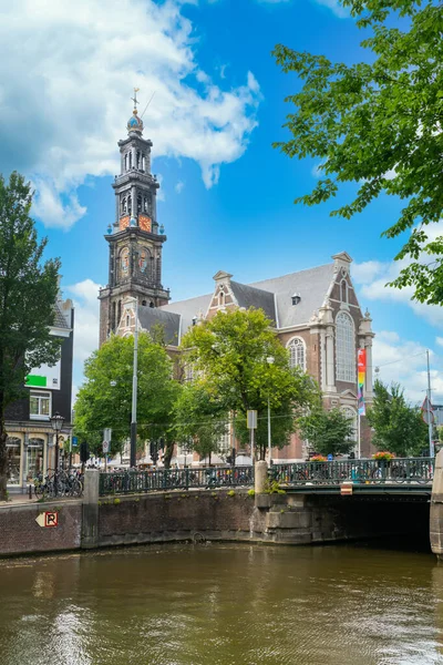 stock image Amsterdam, The Netherlands - 23th July 2020 - The Westerkerk (Western Church) with the Westertoren (Western Tower) on the Prinsengracht next tot the Anne Frank house  in the center of Amsterdam