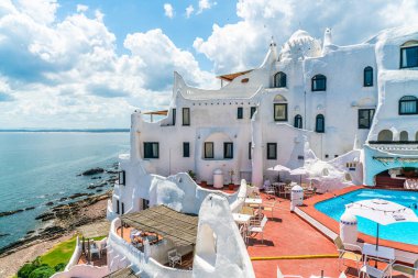Pool and terrace of the famous Casapueblo, the Whitewashed cement and stucco buildings near the town of Punta Del Este, Uruguay, January 28th 2019 clipart