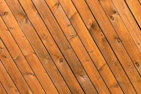 The background is made of wooden pine boards with an inclined diagonal arrangement, close up