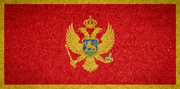 Montenegro flagga på papper bakgrund — Stockfoto