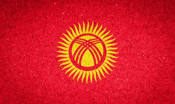 Bandera de Kirguistán sobre fondo de papel —  Fotos de Stock
