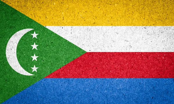 Bandeira das Comores sobre fundo de papel — Fotografia de Stock