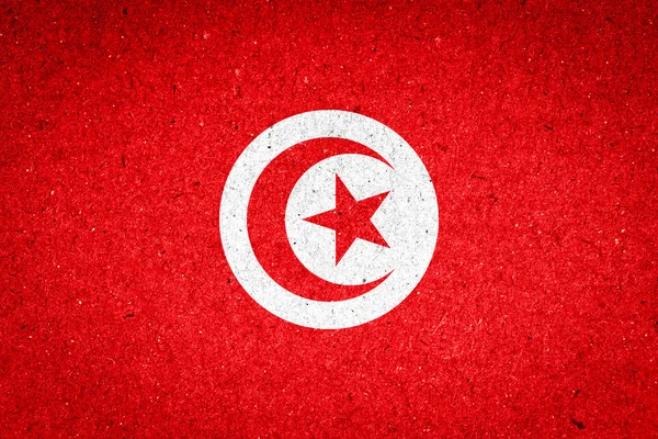 Tunisien flagga på papper bakgrund — Stockfoto