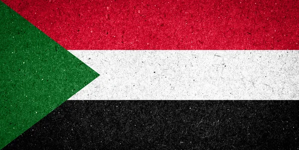 Bandeira do Sudão sobre fundo de papel — Fotografia de Stock