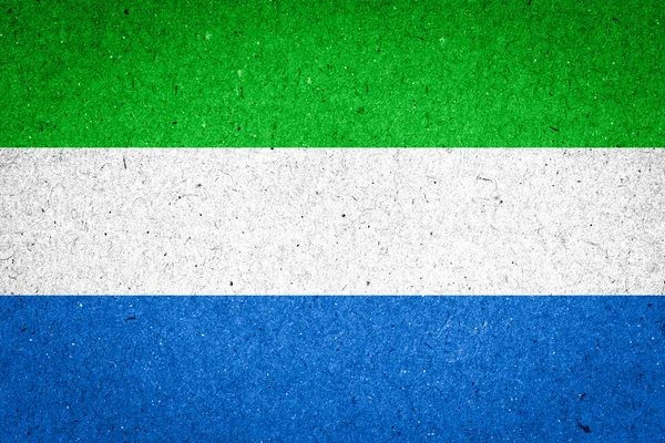 Bandera de Sierra Leona sobre fondo de papel — Foto de Stock