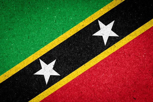 Saint Kitts und Nevis Flagge auf Papier Hintergrund — Stockfoto