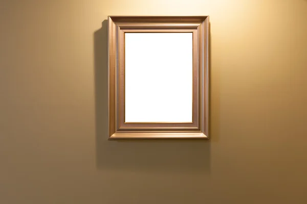 Wooden frame on lighting wall with isolated area — Stock Photo, Image