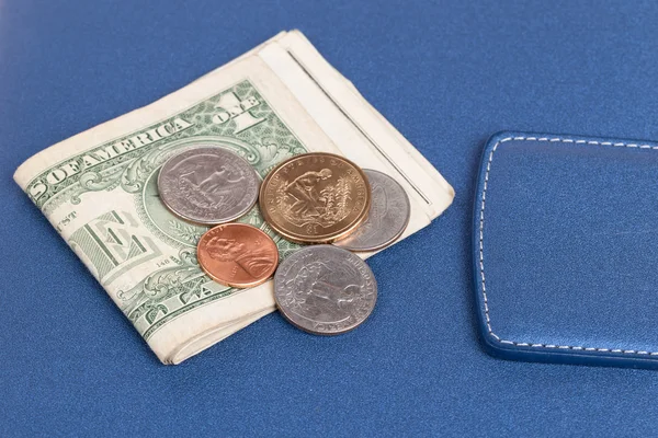 US coins on a blue notebook cover — Stock Photo, Image