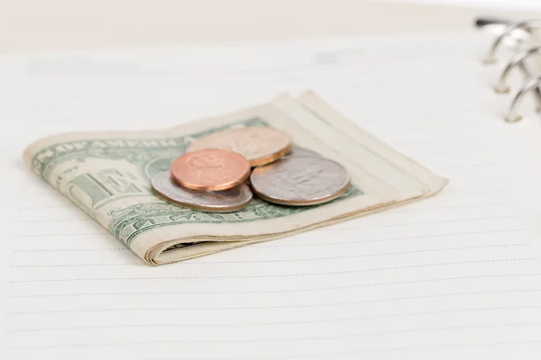US coins on an empty notebook page — Stock Photo, Image