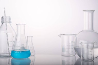 Laboratuvar ekipmanları deney tüpleri ve farklı gruplarda arka plan ışığı olan mataralar. Ürün sunumu için alan.