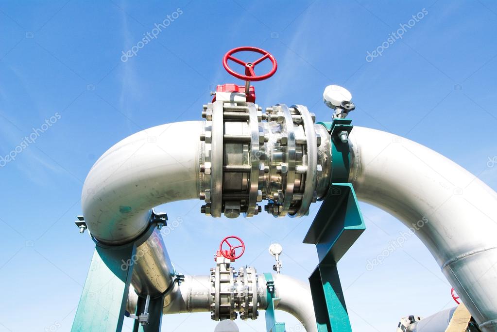 Industrial zone, Steel pipelines and valves against blue sky