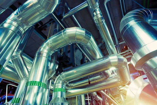 Different size and shaped pipes and valves at a power plant — Stock Photo, Image