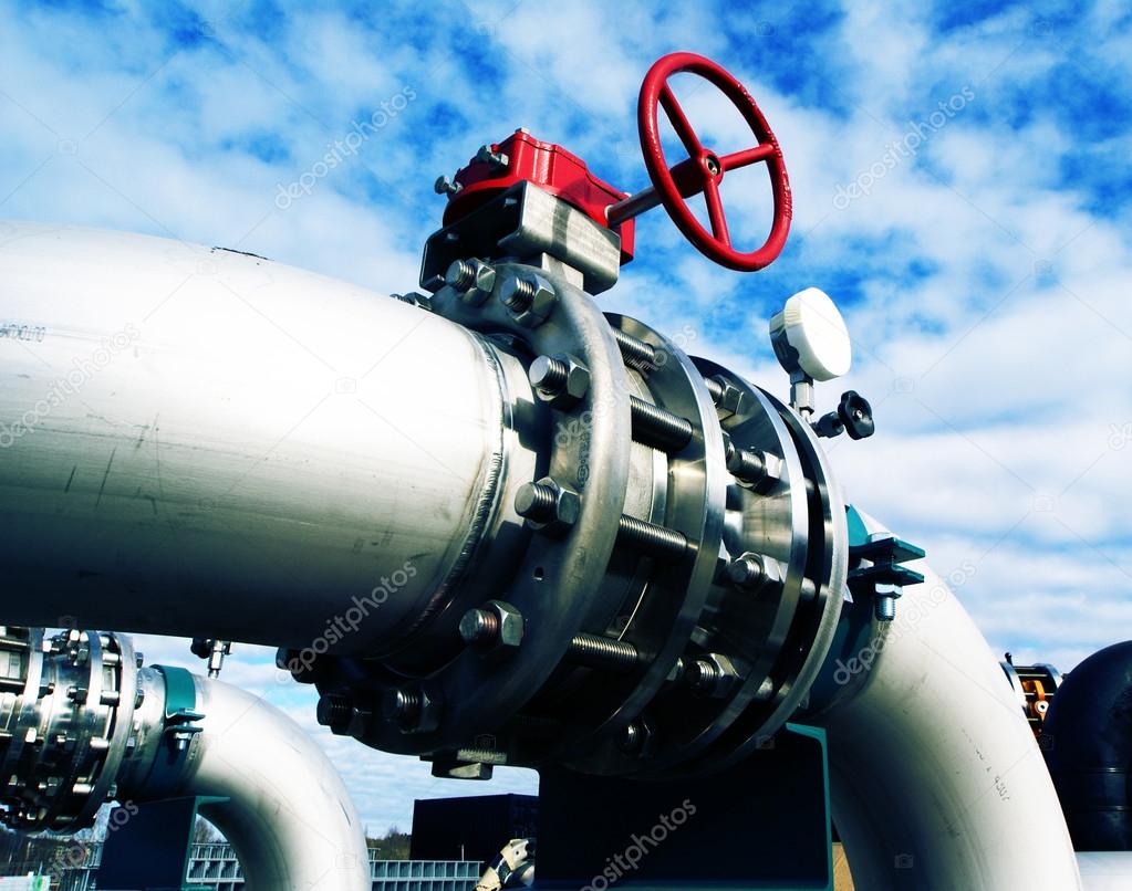 Industrial zone, Steel pipelines and valves against blue sky