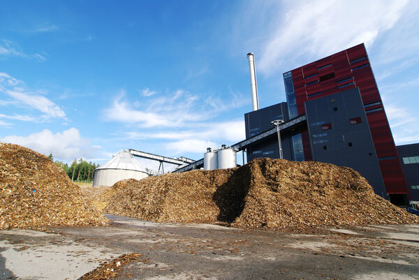 bio power plant with storage of wooden fuel (biomass) against bl