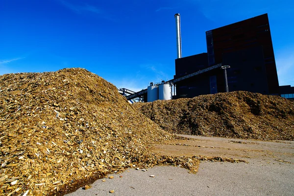 Bio power plant with storage of wooden fuel (biomass) against bl Stock Photo