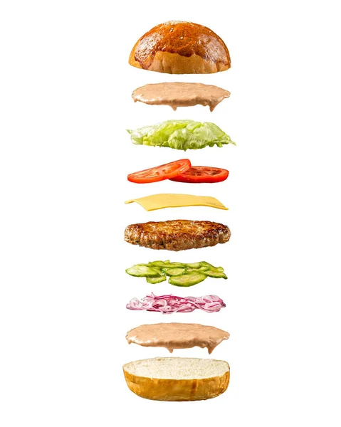 Beyaz arka planda yüzen hamburger malzemeleri