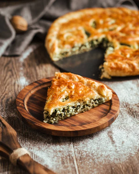 Cut pie with spinach and cheese filling — Stock Photo, Image