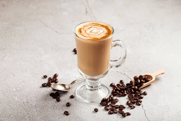 Side view on decorated coffee latte in a glass mug — Stock Photo, Image