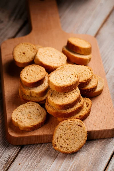 Dried bread crackers on the wooden background — Stock Photo, Image