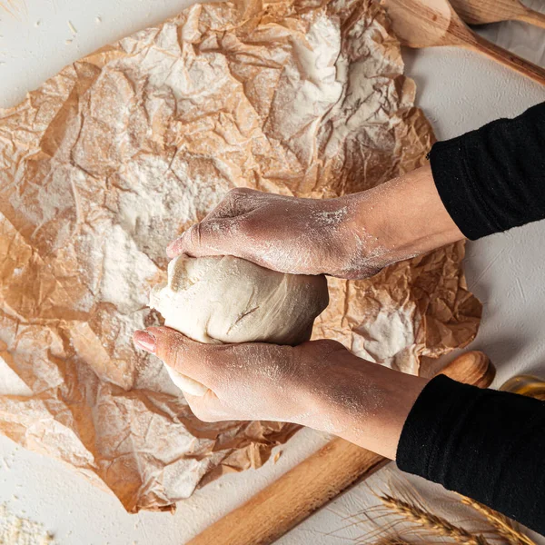 Kneading dough for pizza cooking on the paper — Stock Photo, Image