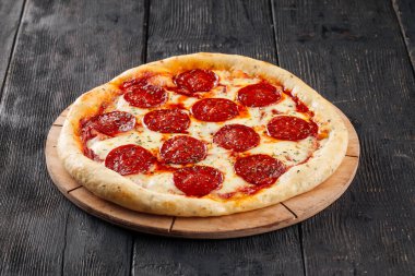 Ahşap arka planda taze fırında peponi pizza.