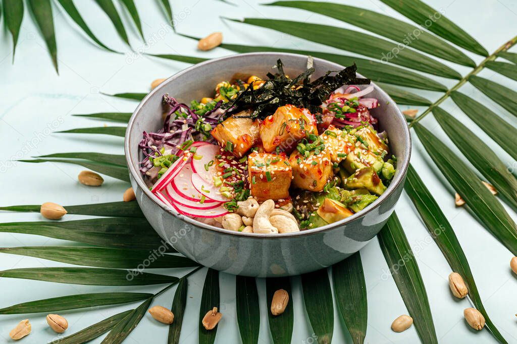 Vegetarian tofu poke bowl with rice and vegetables