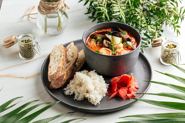 Tom yam soup with seafood and rice with toasts — Stock Photo, Image