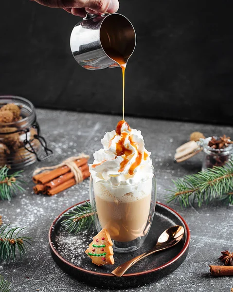 Pouring sweet coffee latte with caramel syrup