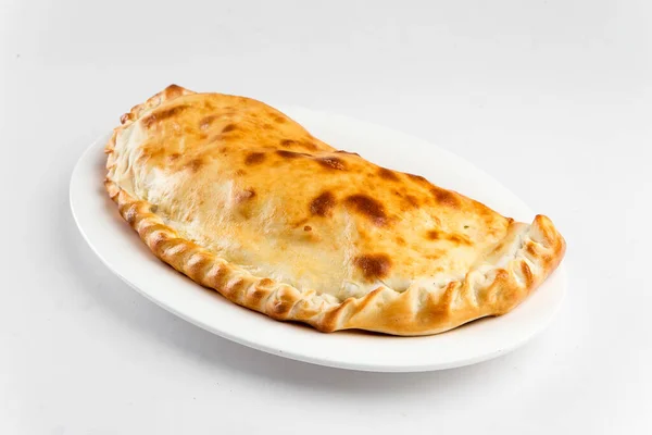 Isolated plate of calzone Italian folded pizza — Stock Photo, Image