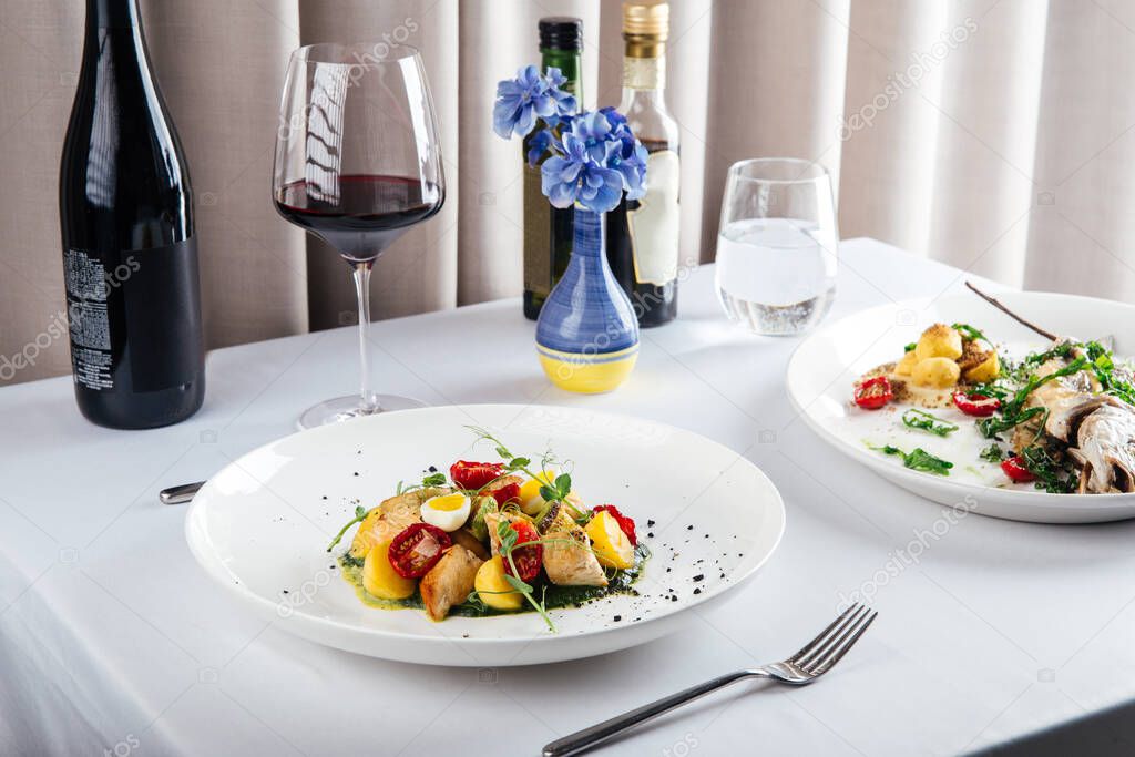 Mediterranean restaurant dishes with red wine