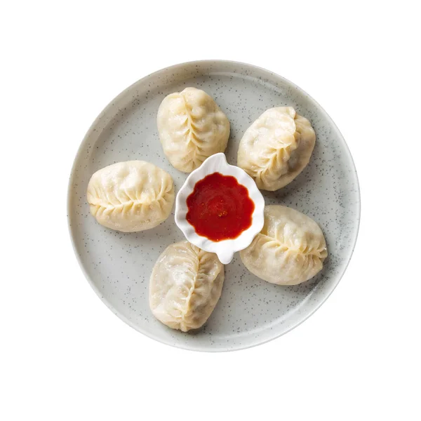 Isolated plate of manti dumplings with red sauce — Stock Photo, Image