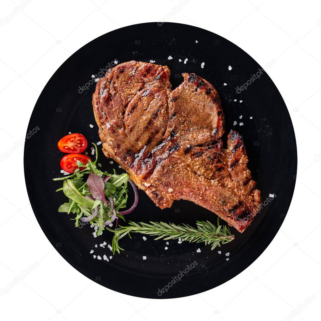 Isolated black plate of grilled beef steak 
