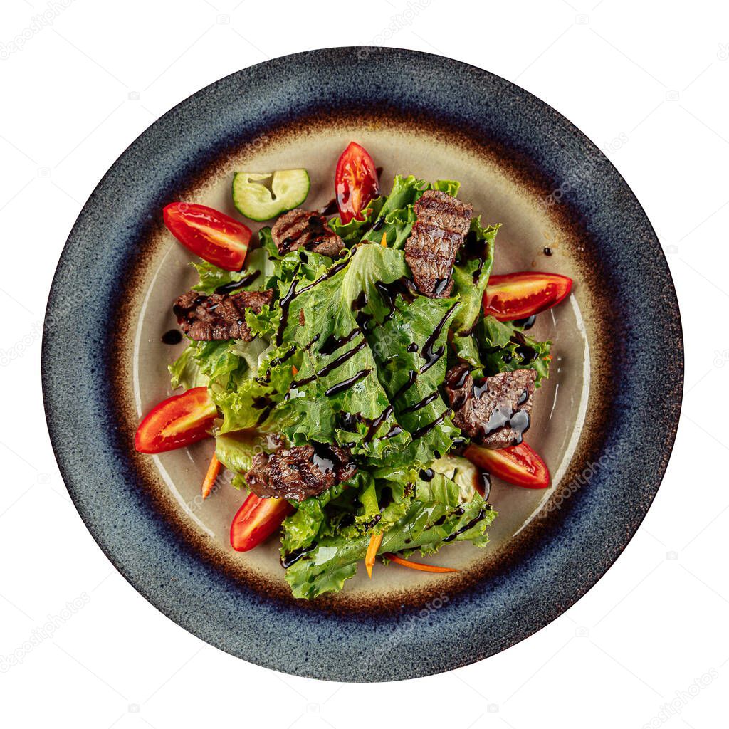 Isolated salad with warm veal and greens