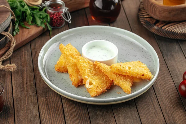 Deep fried cheese triangles with sour cream sauce