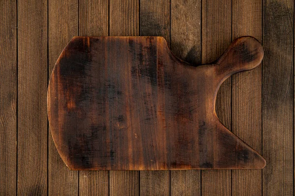 Dark brown wooden cutting board — Stock Photo, Image