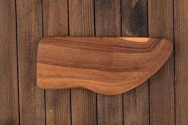 Top view on unusual shape wooden cutting board — Stock Photo, Image